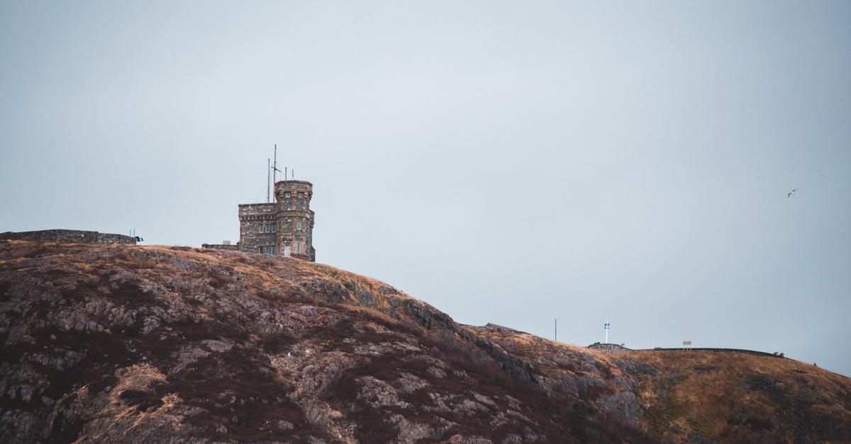 Does a Canadian permanent resident need a transit visa in Canada? - Old tower facade on hill under light sky