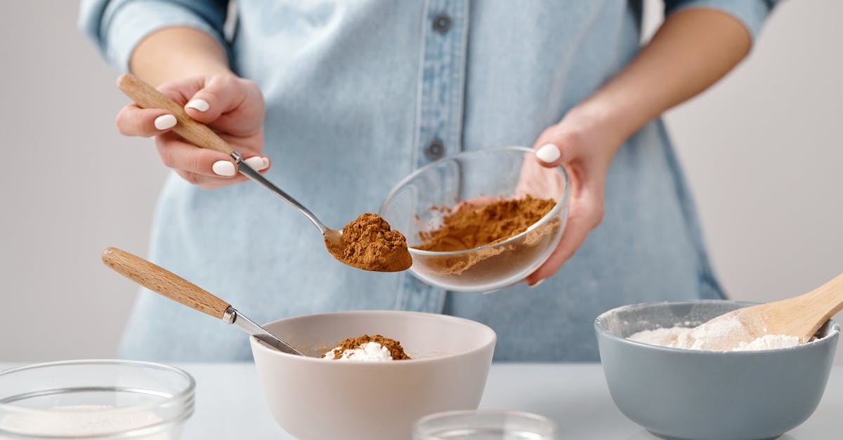 Does adding another bed count as adding another guest on Booking.com? - Person Adding a Spoon of Cinnamon in a Bowl