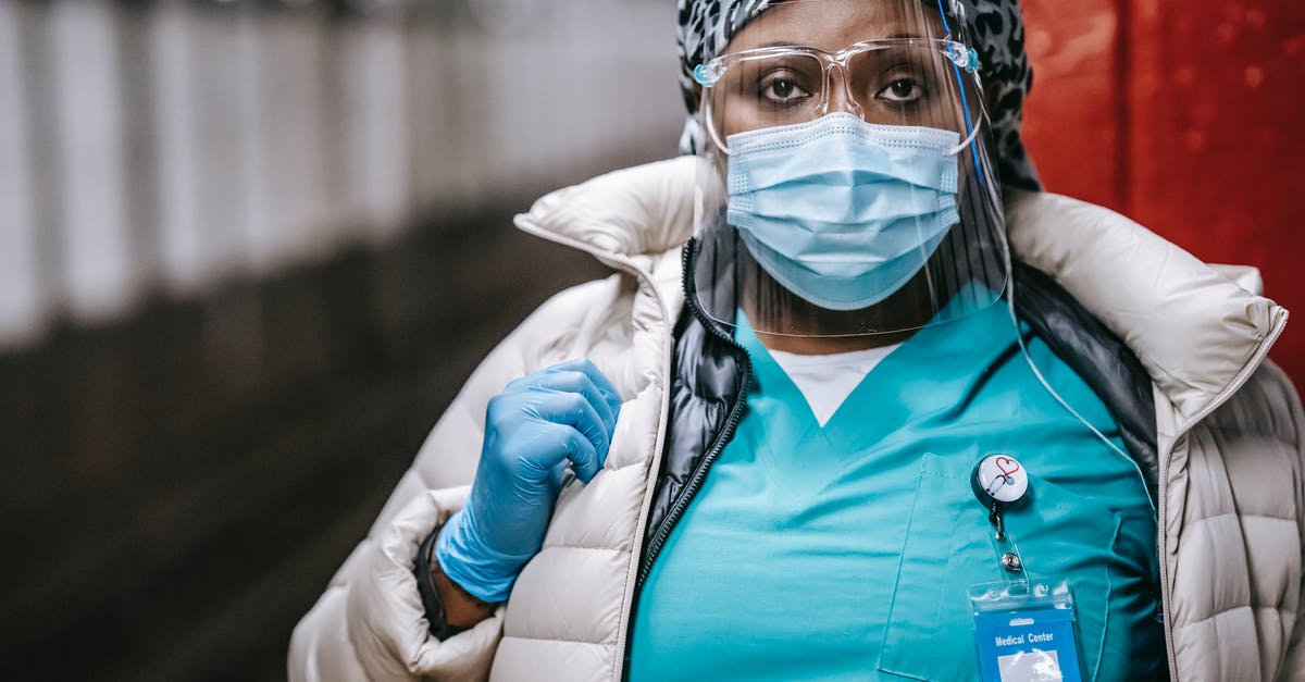 Does Amtrak ever stop at non-Amtrak (commuter only) stations? - Crop serious black nurse in mask standing on train platform