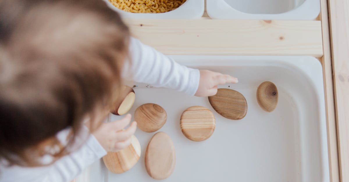 Does an EU citizen need to get health insurance before flying to London? - Crop anonymous child getting brown stones from white container at home Does an EU citizen need to get health insurance before flying to London? - Crop anonymous child getting brown stones from white container at home
