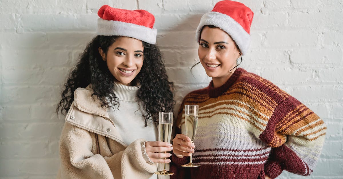 Does anything happen at Lady Bay, Sydney on New Year's Eve, or is it closed like some other beaches? - Cheerful ethnic female friends wearing knitted sweaters and Santa hats standing close while celebrating Christmas together