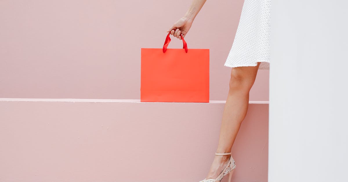 Does Eurowings weigh carry-on bags? - Crop anonymous stylish female in white dress and high heels carrying red shopping bag against pink wall