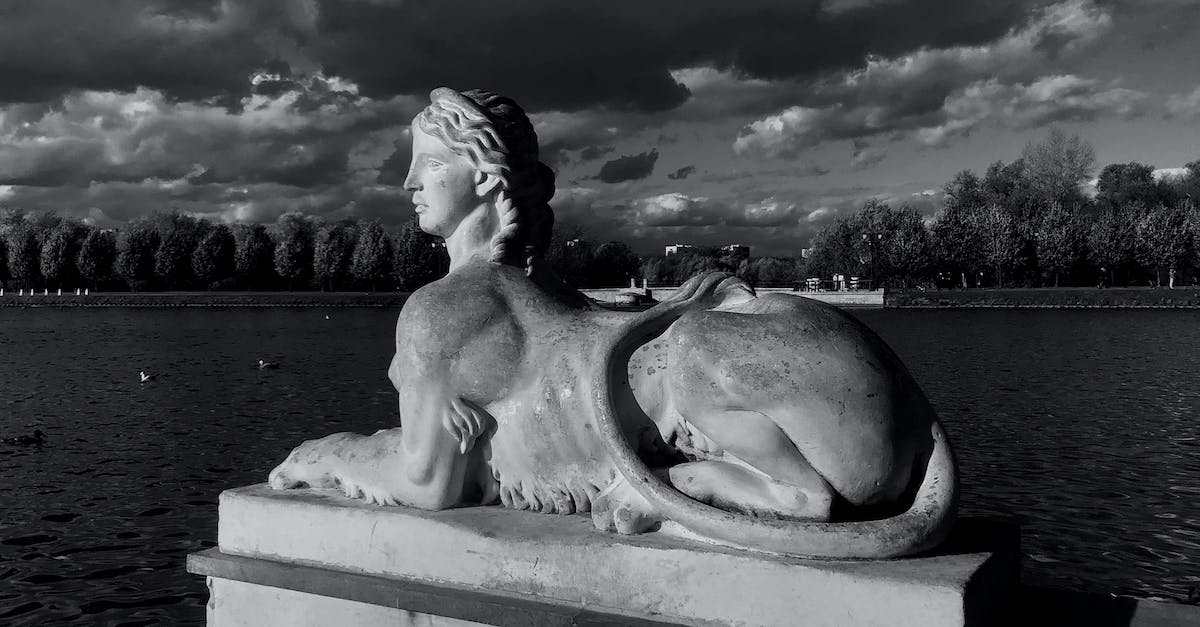 Does Georgia (the country) have a museum or sculpture park of Soviet/Communist/Socialist art? - Black and white of sphinx statue located near rippling pond against cloudy sky in Tsaritsyno park