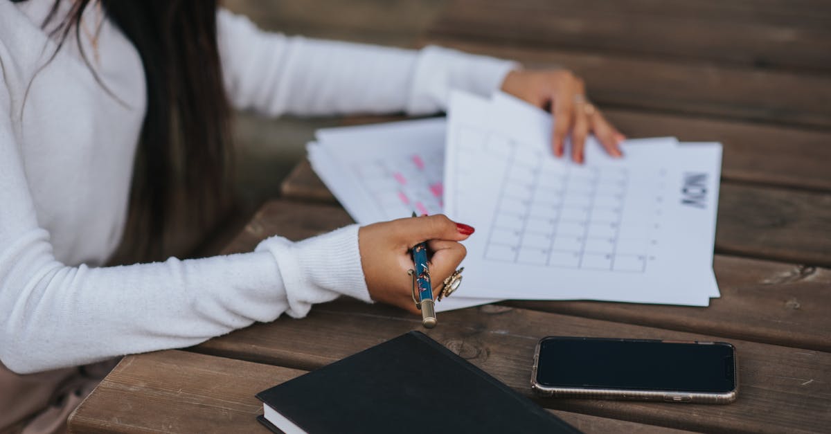 Does Google Maps have ferry schedules and make use of them? - Side view of crop unrecognizable ethnic female office employee working with papers representing month plan