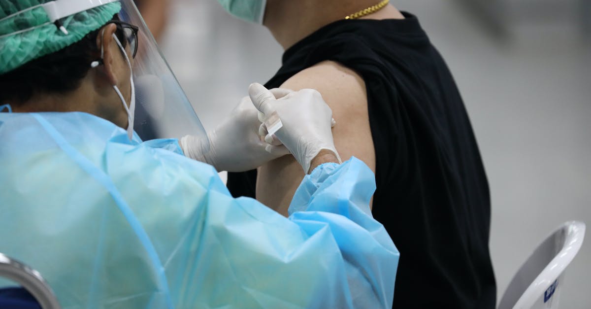 Does Italy require a COVID-19 vaccination less than 9 months ago? - Man in Black Shirt Getting Vaccinated