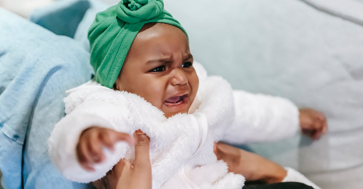 Does my daughter need consent from both parents? - Crying black baby in turban in mother hands