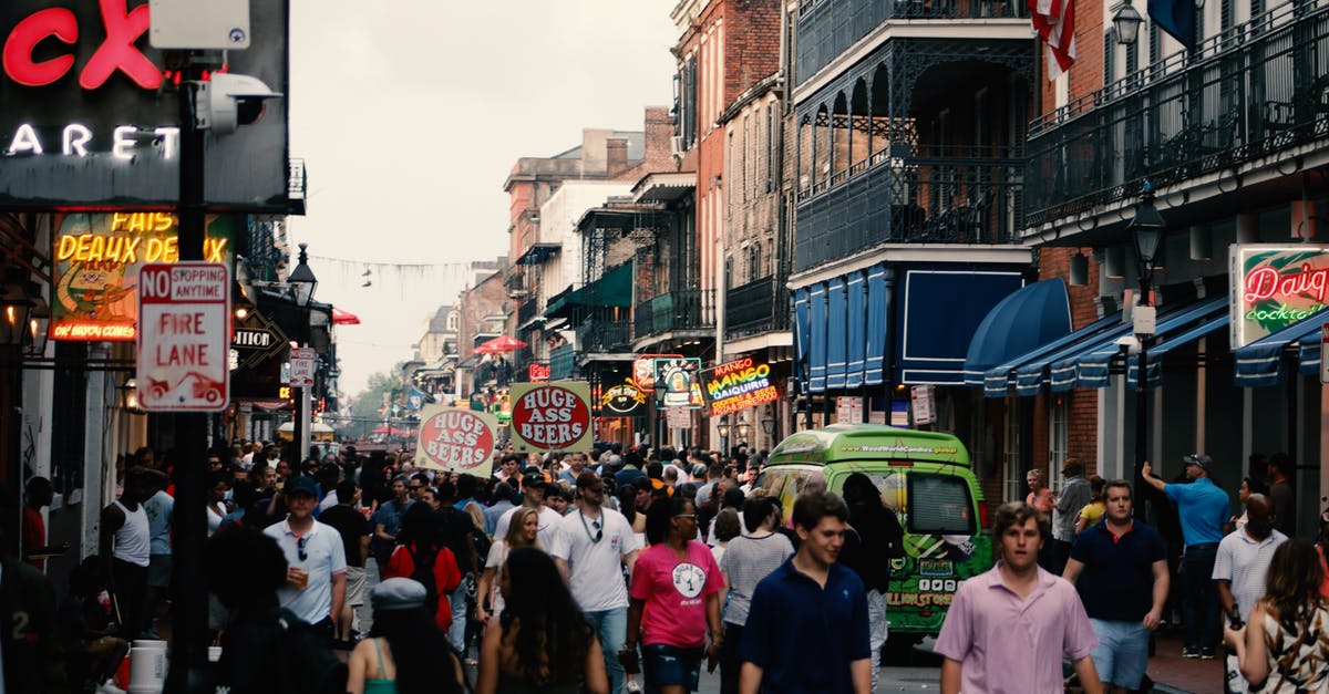 Does New Orleans, LA have a bike share? - People Walking on Paved Road