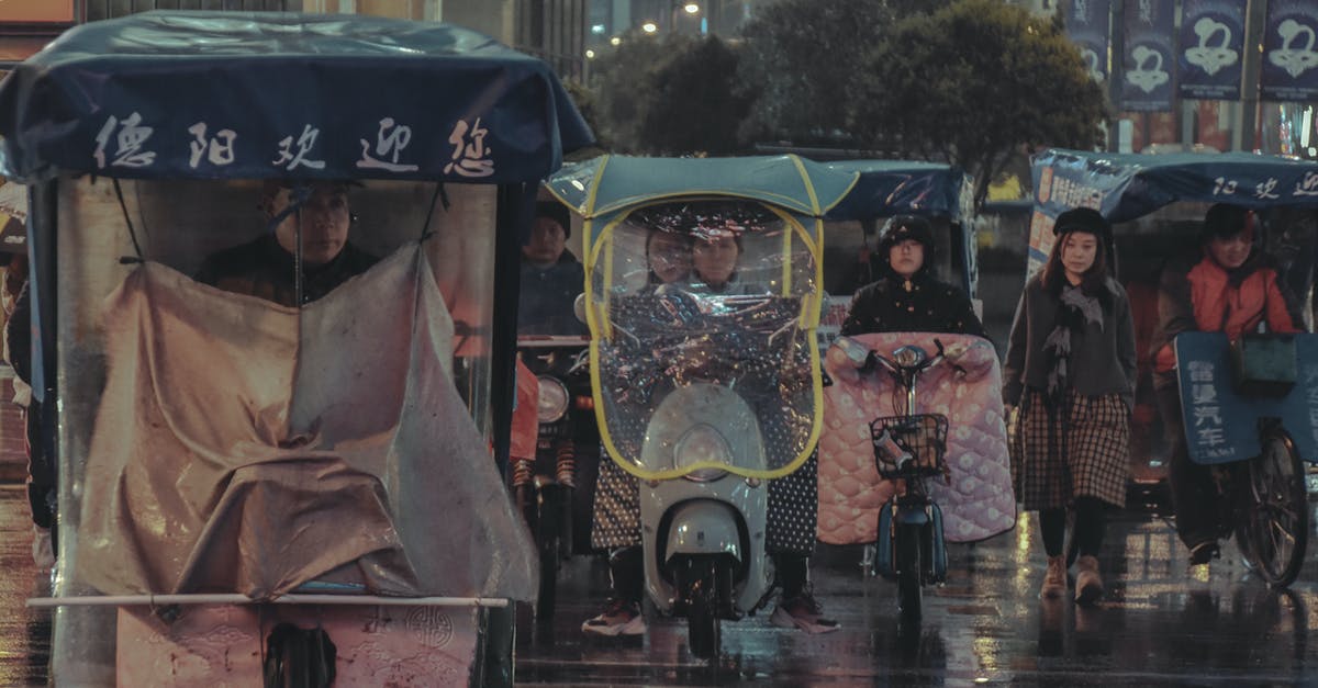 Does pollution in China suggest no bicycling? - People Riding Bicycle or Motorcycle and Walking during Rain