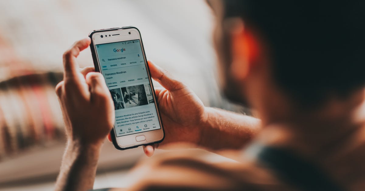 Does "last check in time" apply for connecting flights? - Back view of crop anonymous young male reading news on mobile phone while sitting in bedroom