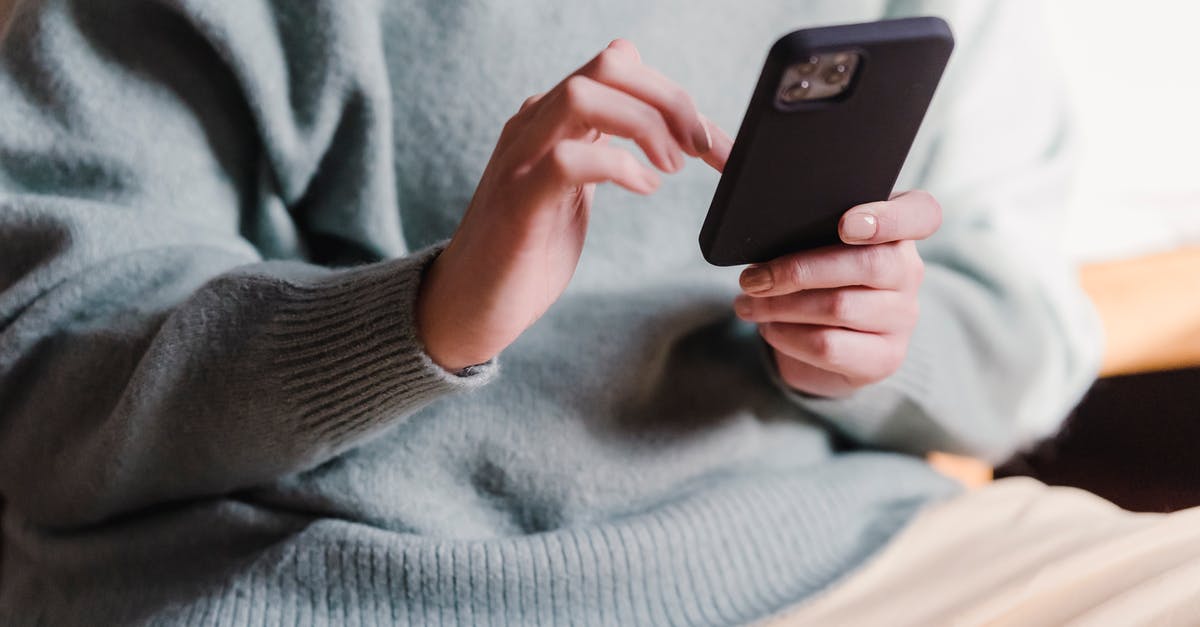 Does "last check in time" apply for connecting flights? - Crop faceless female in casual clothes using smartphone and touching screen while chilling at home