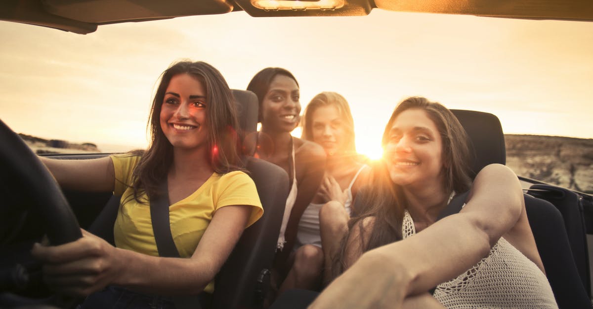 Does renting a car to explore Palawan make sense? - Photo Of Women Sitting On Car