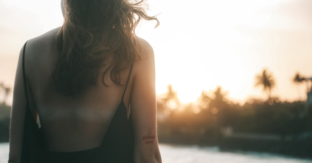 Does sunscreen/suncream stop the amount of skin tan? [closed] - Woman in Black Spaghetti Strap Top Standing on Beach