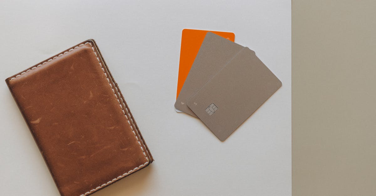 Does the post office at Budapest airport accept credit cards? - Brown Leather Bifold Wallet on White Table