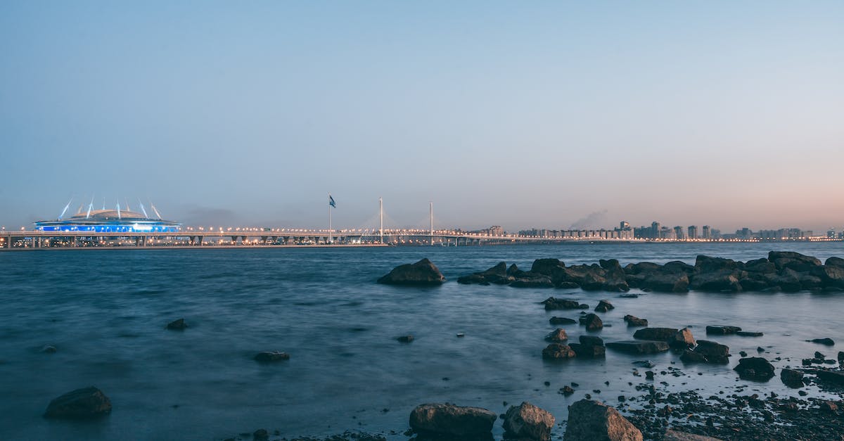 Does the Ukraine-Georgia ferry go via Russia and if so must I have a Russian visa even if I don't disembark? - Krestovsky Island with boulders in water against bridge and football stadium under light sky at sundown in Saint Petersburg Russia