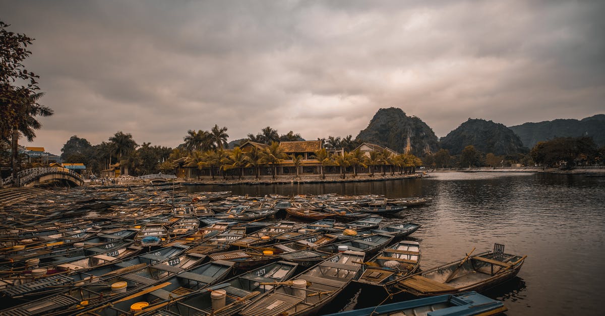 Does Vietnam allow concurrent passports? - Boat on Water Near Green Trees