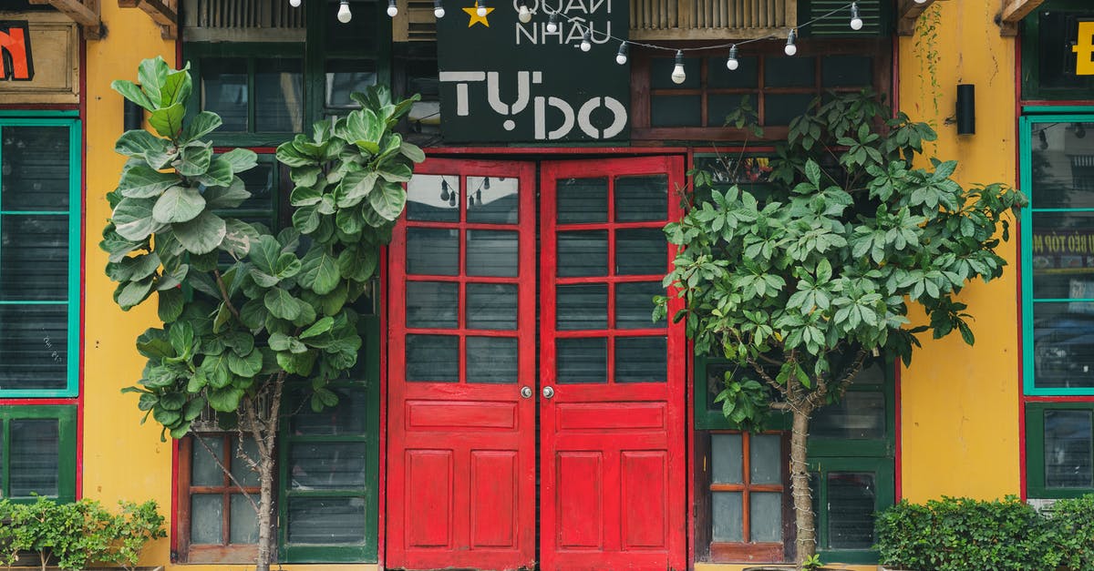 Does Vietnam allow concurrent passports? - A  Restaurant with Red Double Doors at the Entrance