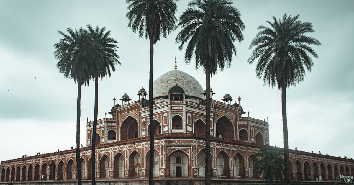 Does visiting Colombia hurts one's travel history? - Low angle of beautiful well maintained garden with palms and ancient building of Humayun s Tomb located in Delhi