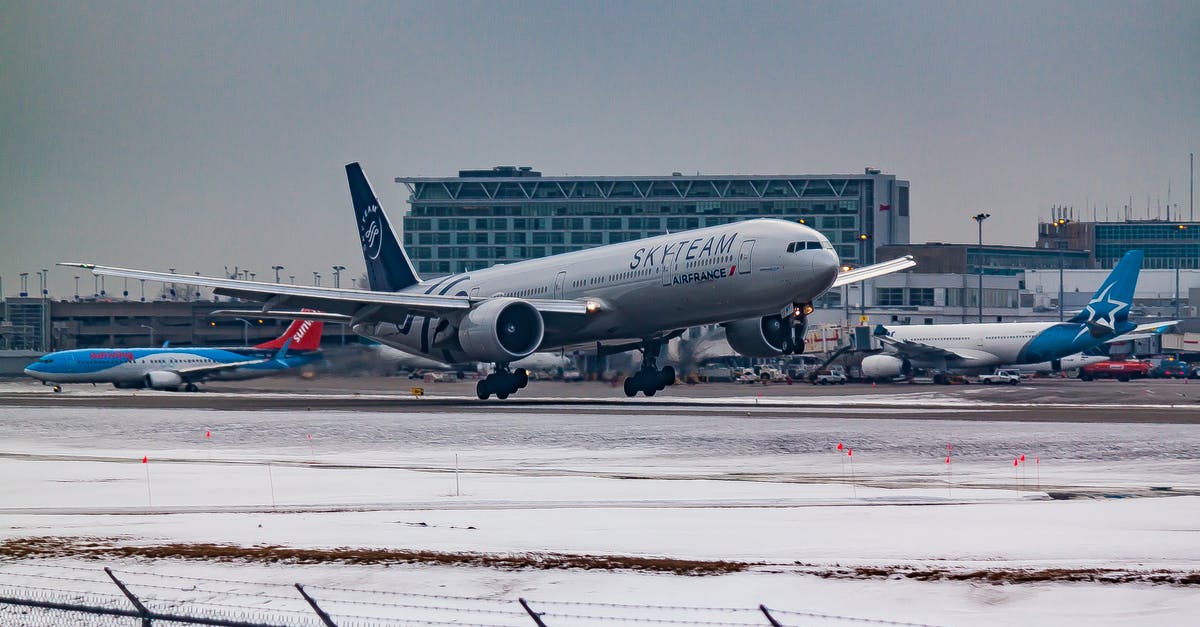 Domestic Flight transfer in LAX to International Flight to Australia - Aircraft flying over runway near airport building