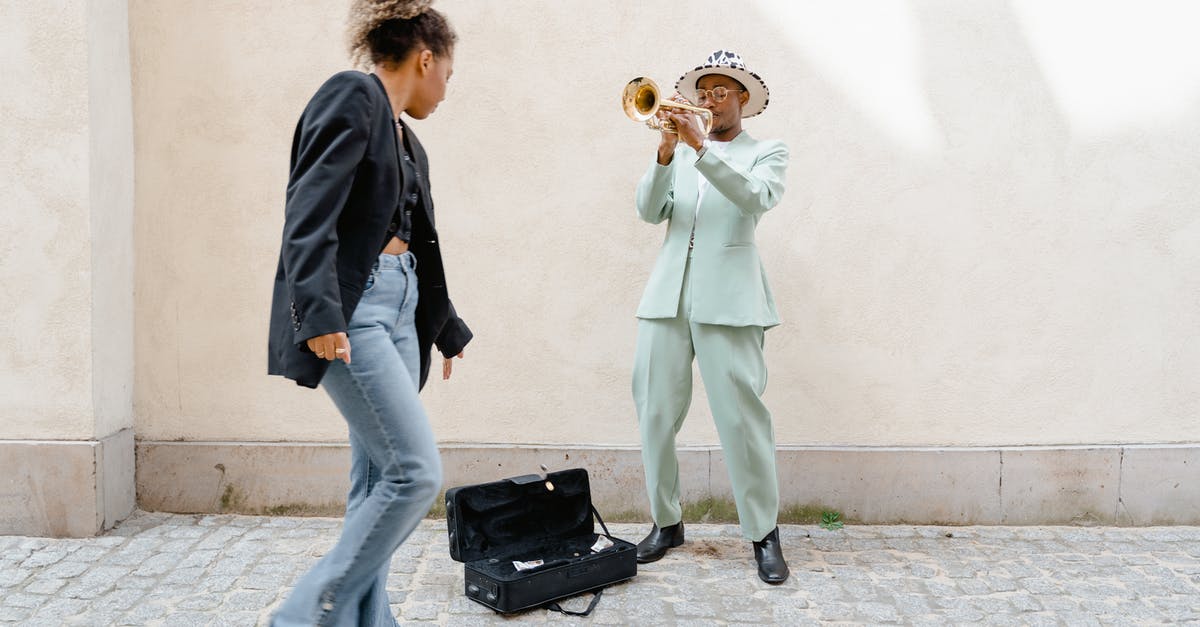 Donating unwanted foreign coins in Sydney - Woman Giving Coins to the Man Playing Trumpet 