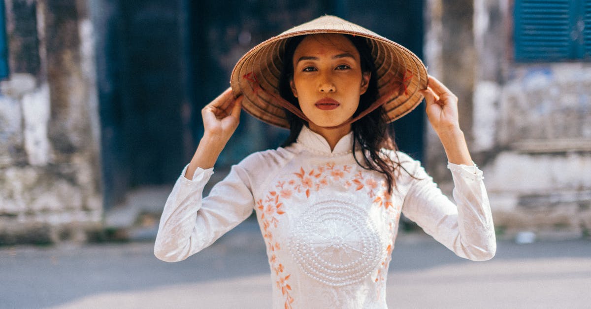 Dos and don'ts at a Vietnamese wedding - Woman Wearing a Conical Hat Looking at Camera