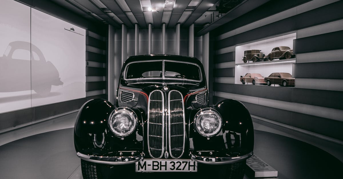 Drive through Germany and Switzerland with barbells as luggage - Selective Focus Photography of Black Car