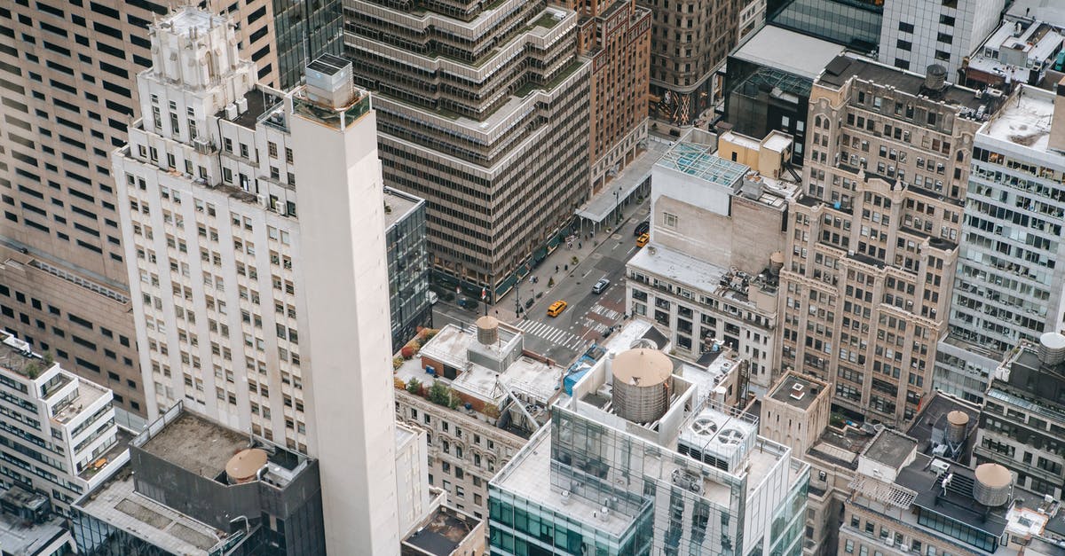 Drive to US, fly from there to Hawaii without passport? - Traffic on road between modern building facades in city