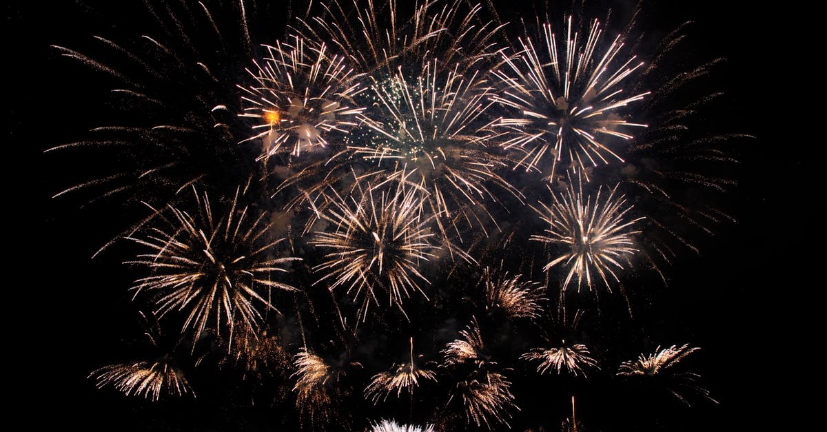 Driving around Banff, Canada in late December - Abstract of vibrant glowing fireworks exploding high in black sky late at night