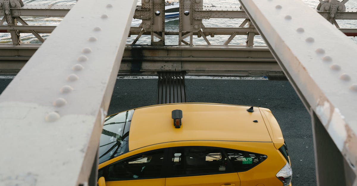 Driving from Seattle to Campbell River, BC - Yellow cab driving on metal bridge