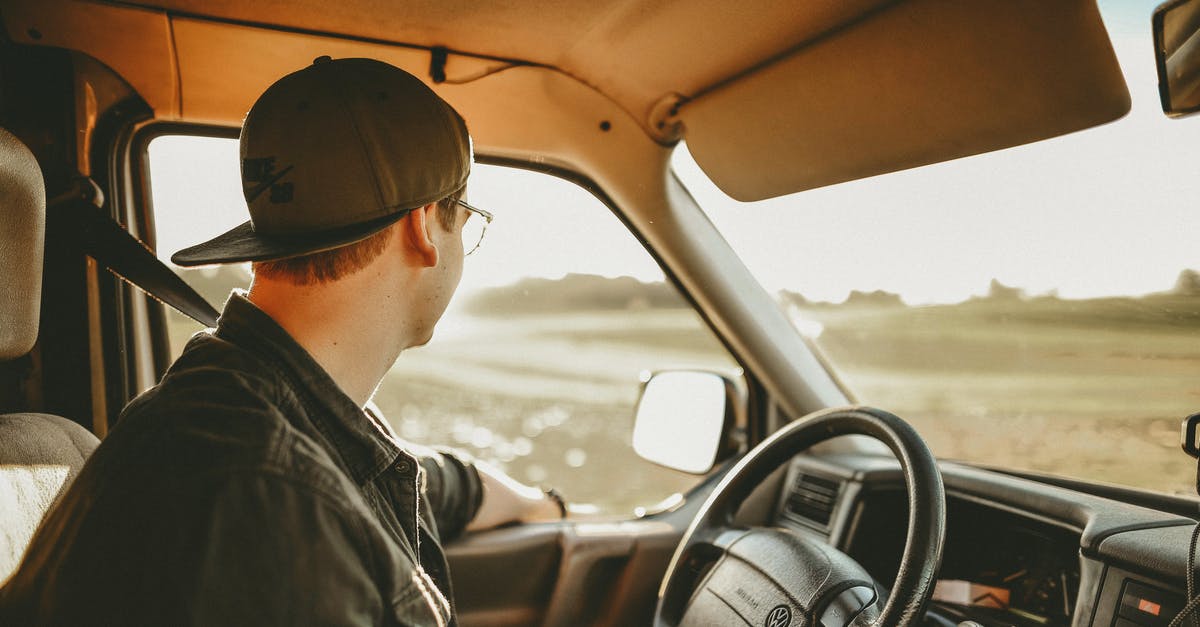 Driving in California with a foreign driver license [closed] - Man Wearing Black Denim Jacket in Driver's Seat