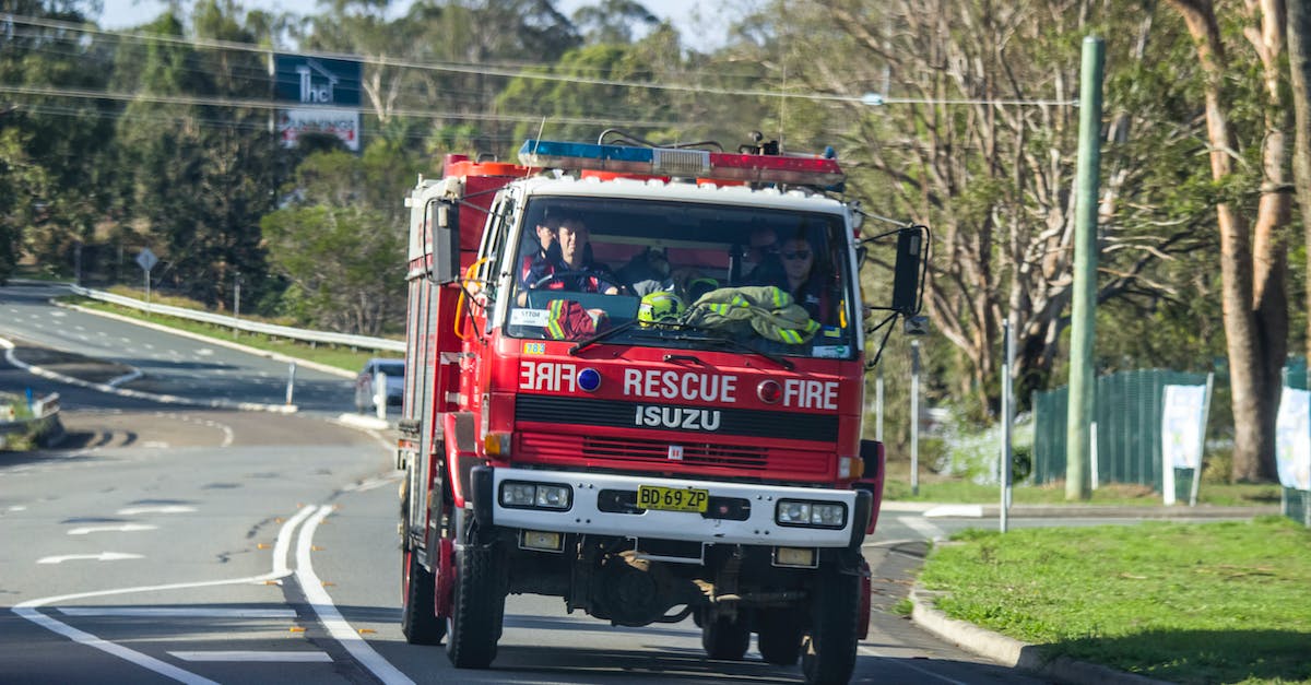 Driving license in Australia - Red Fire Truck With Firemen On The Road