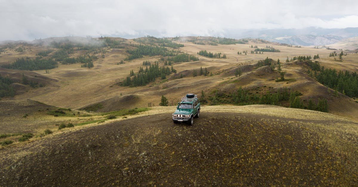 Driving SUVs in the Namibian desert - Lonely car driving through mountain valley