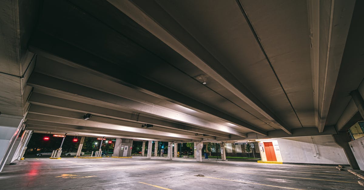 Driving time around Iceland - Entrance to underground parking with empty spaces under concrete roof at night time