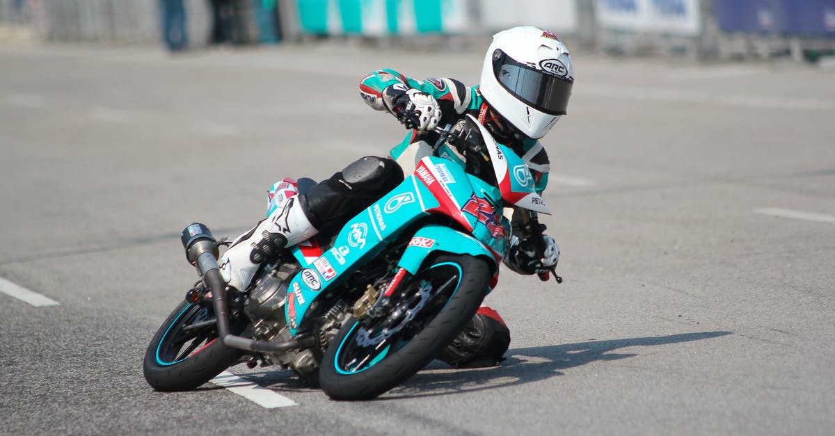 Driving to Yellowknife, NT - Biker Riding a Teal Sport Bike