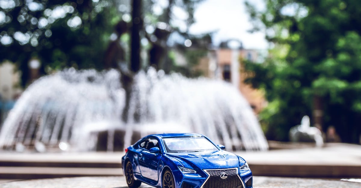 Driving with International Driving Permit in Taiwan - Blue Die-cast Toy Car Across Outdoor Fountain