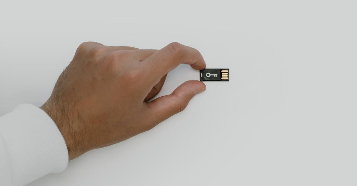 DS-160 Security and Background Information for UK Banned Applicants - Hand Holding a USB Flash Drive