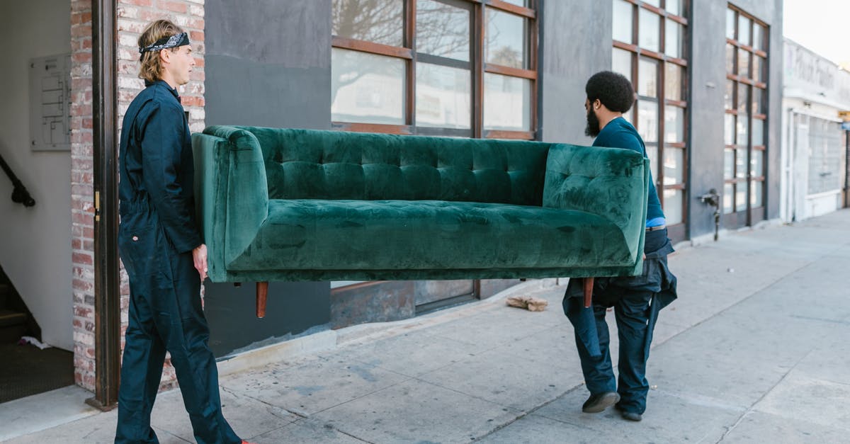 DS 160 Marital Status [closed] - Man in Black Jacket and Blue Denim Jeans Standing Beside Green Couch