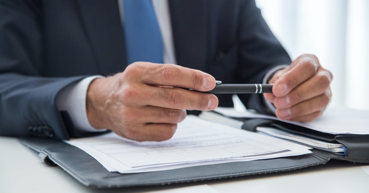 Dual citizen with different dates of birth on documents [closed] - Man in Blue Suit Writing on White Paper