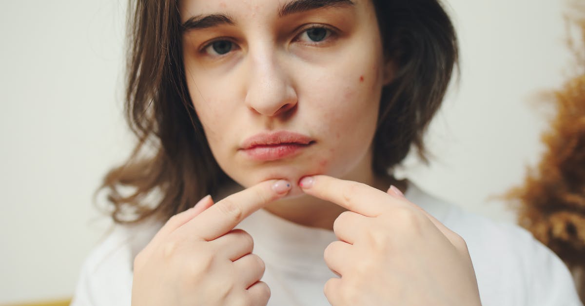 Dual citizenship [closed] - Woman in White Shirt Holding Her Chin