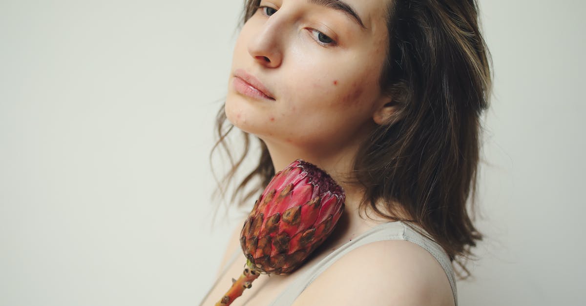 Dual citizenship [closed] - Woman in White Tank Top Holding Strawberry Fruit