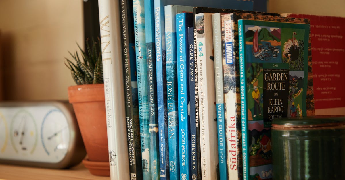 Dual citizenship different information [closed] - Wooden shelf filled with different interesting books near pots with green plants at home