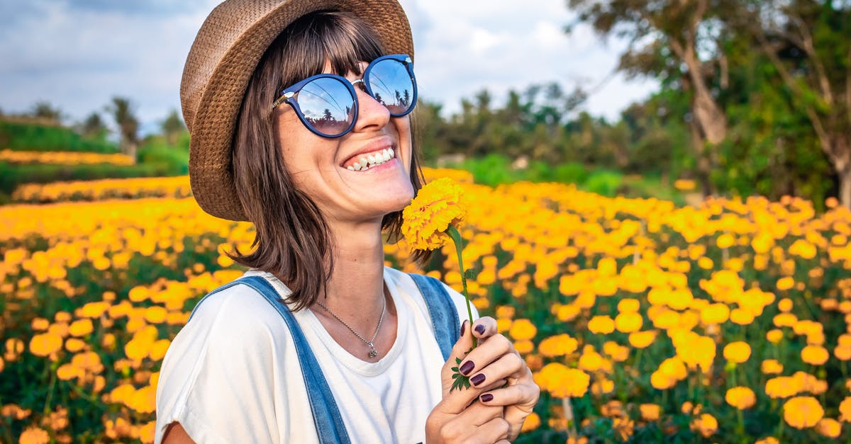 Dual passport holder travel to Bali - Woman Holding Yellow Petaled Flowers