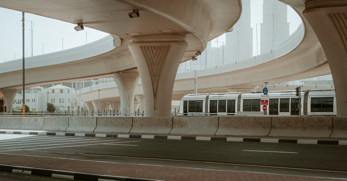 Dubai airport enquiries - White and Black Train in a Train Station