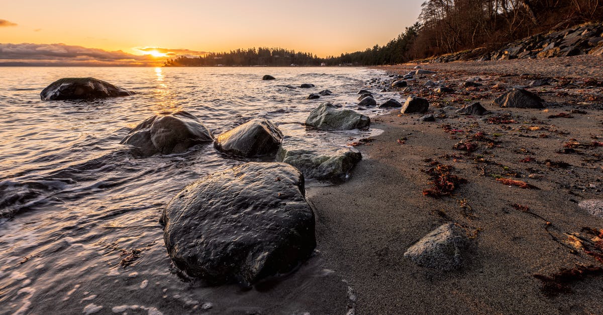 Dublin-Newark-Vancouver. Two-hour layover - Gray Rocks on Seashore during Sunset