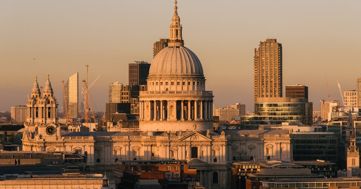 Duration outside the UK [duplicate] - Aged famous cathedral with dome framed by the spires of churches located near buildings against modern skyscrapers on streets of London