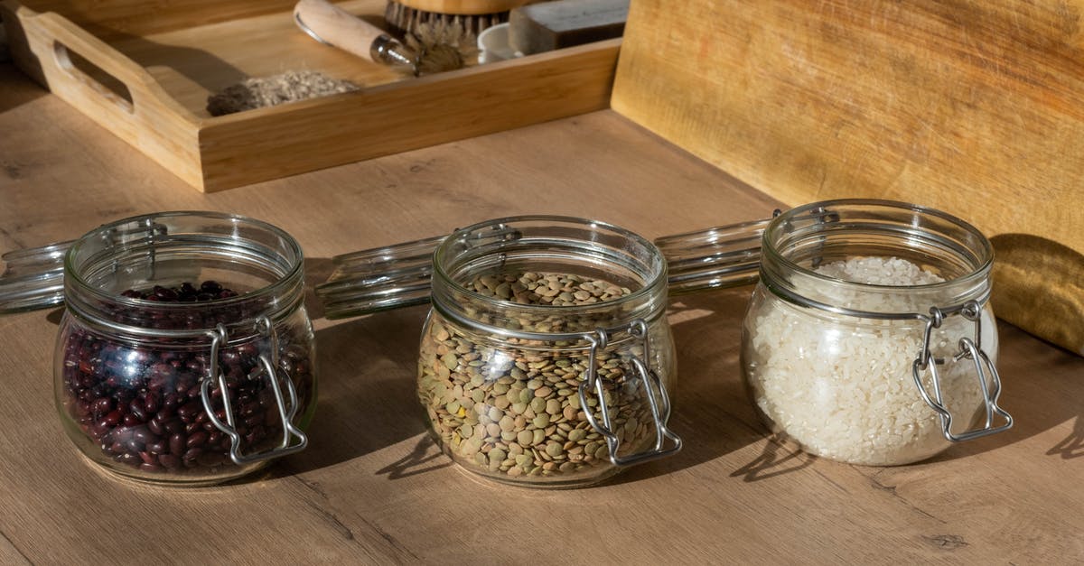 Duty free allowance for rice and beans in Switzerland - Clear Glass Jars with Raw Beans, Seeds and Rice on Brown Wooden Table