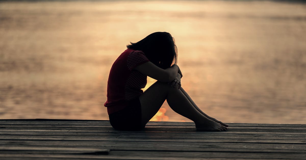 Ear pain when flying? [duplicate] - Woman Looking at Sea While Sitting on Beach