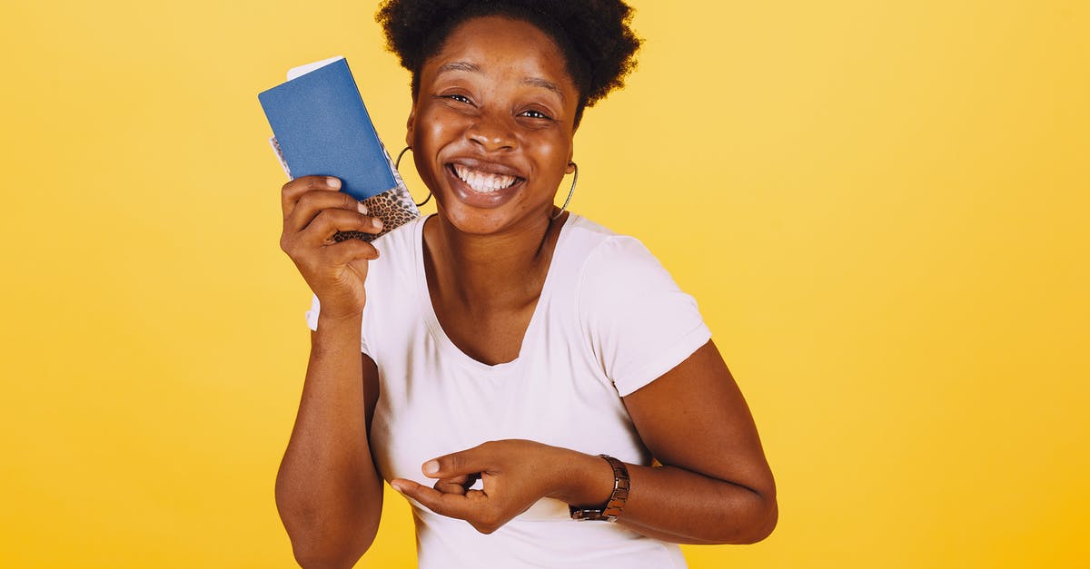 Easier to travel on a Swiss passport than American? - Smiling Woman in White Shirt Holding Her Passport