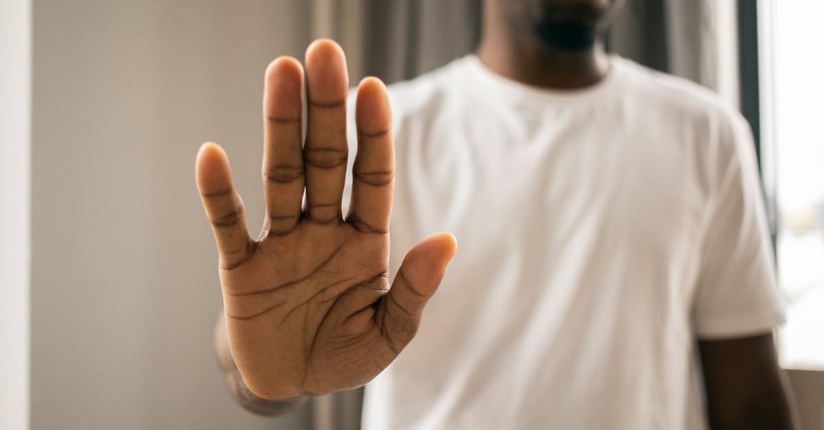 easyJet won't refund because it says 'no-show' but they denied boarding - Unrecognizable black man showing stop gesture