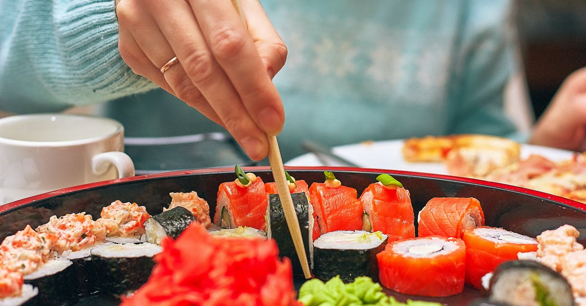 Eating fish eye in Japan - Close-up of Person Eating Sushi