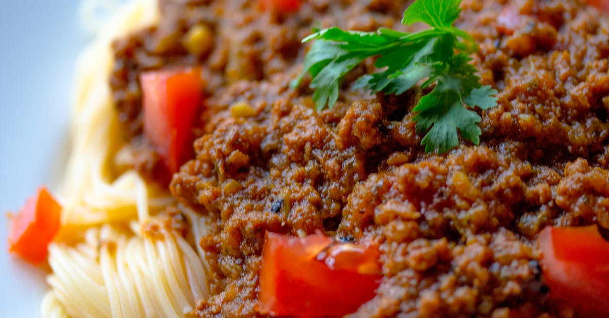 Eating pasta with raw minced meat in Italy - Cooked Pasta With Sliced tomatoes and Green Leafy